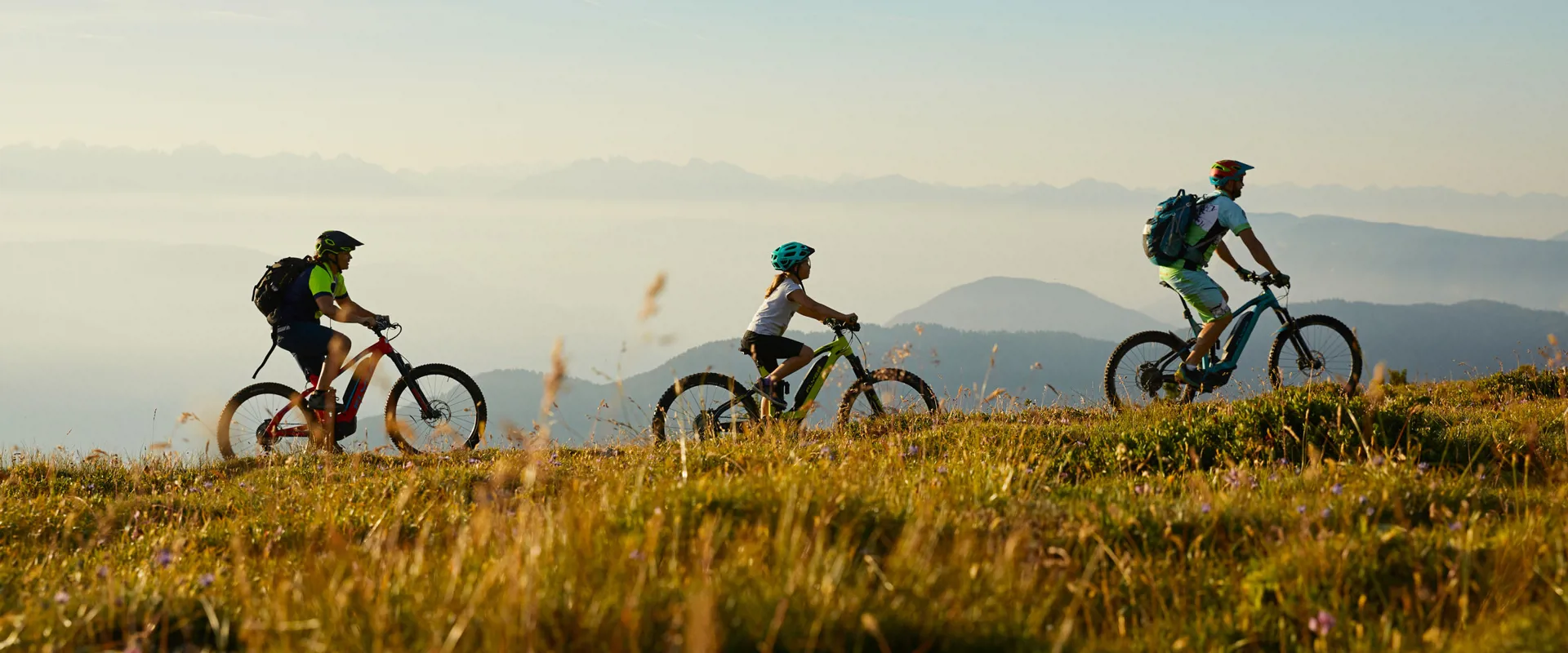 Cyclists riding e-bikes in nature